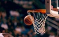 A basketball elegantly passes through the net in an exciting moment of the game Royalty Free Stock Photo