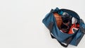 Basketball equipment and accessories. Top view of a sports bag with uniform, basketball ball, sneakers and bottle of