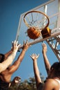 Basketball is a fast-moving game. Closeup shot of a group of sporty young men playing basketball on a sports court. Royalty Free Stock Photo