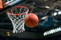 Basketball flies through air toward hoop, exciting sports action Royalty Free Stock Photo