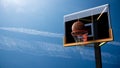 Basketball going into hoop on beautiful blue sky background. Sport and Competitive game concept. 3D illustration. Royalty Free Stock Photo
