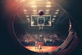 The basketball is going into the hoop to score before the game time is over in the basketball court. Sport and Athlete concept. Royalty Free Stock Photo