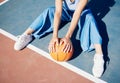 Basketball, hands and woman on the outdoor court floor with urban fashion for influencer beauty. Sport, model and young