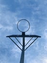 Low angle shot of basketball hoop against blue sky background. Royalty Free Stock Photo