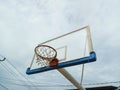 Basketball hoop against the background of the sky with clouds. Royalty Free Stock Photo