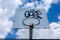 Basketball hoop against cloudy sky in urban setting