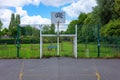 Basketball hoop against cloudy sky in urban setting