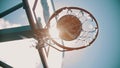 A basketball hoop. A ball gets in the target. Bright sunlight Royalty Free Stock Photo