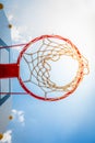 Basketball hoop with blue sky.