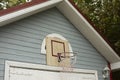 Basketball hoop on building. Sports equipment in yard