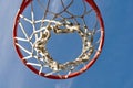 Basketball Hoop with Clouds and Blue Sky