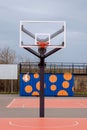 Basketball hoop with net on an outdoor court with sky background. Royalty Free Stock Photo