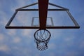 Basketball hoop with net on an outdoor court with sky and clouds Royalty Free Stock Photo