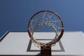 Basketball hoop on outdoor basketball court with blue sky background. Low angle view Royalty Free Stock Photo