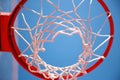Basketball hoop, red ring and net, blue sky background, underview Royalty Free Stock Photo