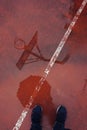 Basketball hoop reflection on the puddle