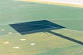 Basketball hoop shadow on a colored playground field Italy, Europe Royalty Free Stock Photo