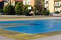 Basketball hoop shadow on a colored playground field Italy, Europe Royalty Free Stock Photo