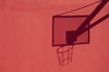 Basketball hoop shadow on the red wall Royalty Free Stock Photo