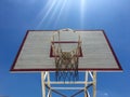 Basketball hoop with sky and light ray