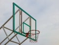 Basketball hoop in sunlight and blue sky with clouds on background for goal concept business and success. Royalty Free Stock Photo