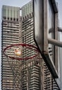 Basketball hoop and white net on Basketball backboard and street lamp against modern condo building background Royalty Free Stock Photo