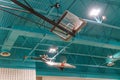 Basketball hoops folded towards the ceiling in a school gymnasium - view from underneath