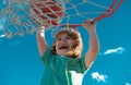 Basketball kid player running up and dunking the ball Royalty Free Stock Photo
