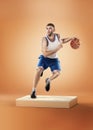 Basketball player in action on orange background