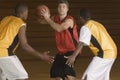 Basketball Player With Ball Being Blocked By Opponents Royalty Free Stock Photo