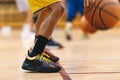 A basketball player bounces a basketball during a training session. Youth basketball team on practice unit Royalty Free Stock Photo