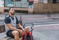 Basketball player is concentrated sitting on a bench in a city street Royalty Free Stock Photo