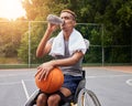 Basketball player, drinking water or man in wheelchair for sports break, rest or fitness electrolytes on court. Person Royalty Free Stock Photo