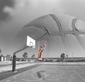 Basketball player dunking by the sea Royalty Free Stock Photo