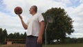 Basketball player juggles basketball ball