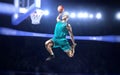 Basketball player making slam dunk on basketball arena Royalty Free Stock Photo