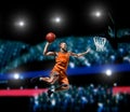 Basketball player making slam dunk on basketball arena Royalty Free Stock Photo