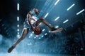 Basketball player on big professional arena during the game. Basketball player making slam dunk.