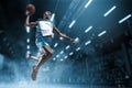 Basketball player on big professional arena during the game. Basketball player making slam dunk. Royalty Free Stock Photo