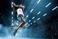 Basketball player on big professional arena during the game. Basketball player making slam dunk. Royalty Free Stock Photo