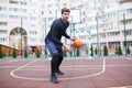 Basketball player in the open stadium trains, runs with a ball. Royalty Free Stock Photo