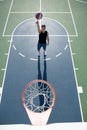 Basketball player shooting ball in hoop outdoor court. Urban youth game. Concept of sport success, scoring points and Royalty Free Stock Photo