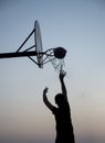 Basketball player silhouette shooting a goal