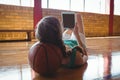 Basketball player using tablet computer in court