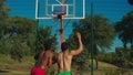 Basketball players fighting for rebound on court