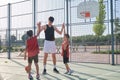 Basketball players high fiving with their coach, one has a leg prosthesis. Royalty Free Stock Photo