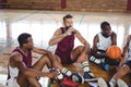 Basketball players interacting while relaxing Royalty Free Stock Photo