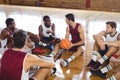 Basketball players interacting while relaxing Royalty Free Stock Photo