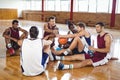 Basketball players interacting while relaxing Royalty Free Stock Photo