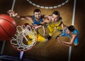 Four basketball players during scrimmage on nasketball arena